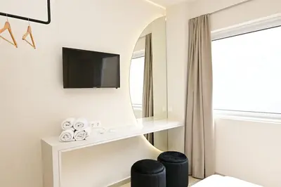 a hotel room with a mirror and a tv at Omonia Flow Two by ΜΡS in Athens