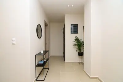 a hallway with a clock and a potted plant at Omonia Flow Two by ΜΡS in Athens