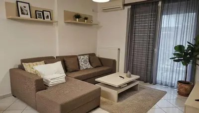 a living room with a couch and a coffee table at The Calm Corner of Ampelokipoi in Athens