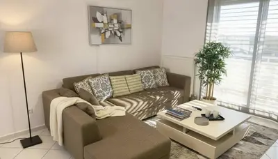 a living room with a couch and a coffee table at The Calm Corner of Ampelokipoi in Athens