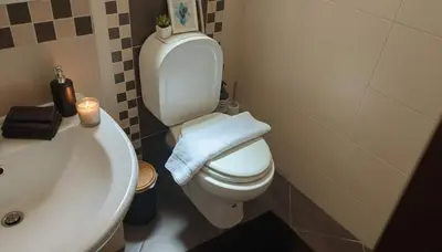 a bathroom with a white toilet and a sink at The Calm Corner of Ampelokipoi in Athens