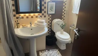 a small bathroom with a sink and a toilet at The Calm Corner of Ampelokipoi in Athens