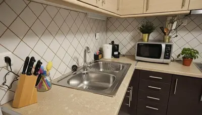 a kitchen with a sink and a microwave at The Calm Corner of Ampelokipoi in Athens