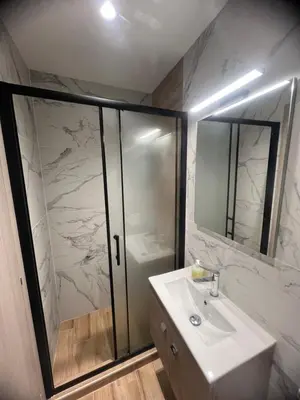 a bathroom with a white sink and a shower at Μοντέρνο στούντιο στη δάφνη in Athens