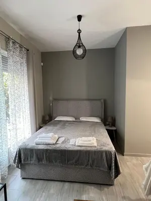 a bedroom with a bed and a pendant light at Μοντέρνο στούντιο στη δάφνη in Athens