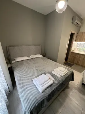 a bedroom with a bed with towels on it at Μοντέρνο στούντιο στη δάφνη in Athens