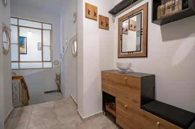 a bathroom with a dresser and a mirror on the wall at Attiki Haven - 4BR Stay - Steps from Metro by ΜΡS in Athens
