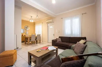 a living room with a couch and a table at Modern City Retreat in Kallithea in Athens