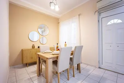 a dining room with a wooden table and chairs at Modern City Retreat in Kallithea in Athens