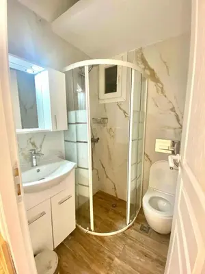 a bathroom with a shower and a toilet and a sink at Cozy 30sqm Studio in the Heart of Athens in Athens