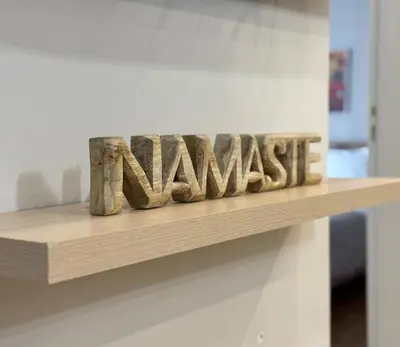 a shelf with the wordamine spelled out in wood at Athens #1 Experience in Athens