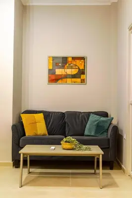 a living room with a couch and a coffee table at Athens #1 Experience in Athens