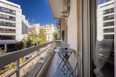 a balcony with a table and a view of a city at Athens #1 Experience in Athens