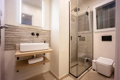 a bathroom with a sink and a shower at Athens #1 Experience in Athens