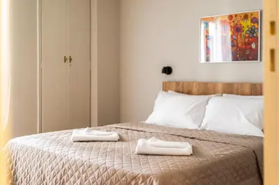 a bedroom with a bed with two towels on it at Athens #1 Experience in Athens