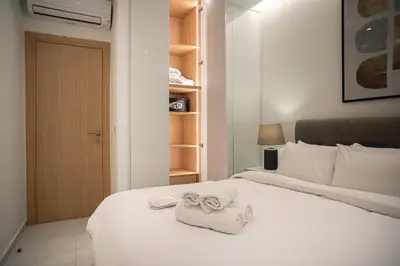 a bedroom with a bed with towels on it at Koukaki Urban Suites in Athens
