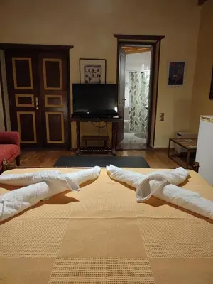a living room with two white towels on a rug at The Wooden Nest, Cozy Private Room in Spáta