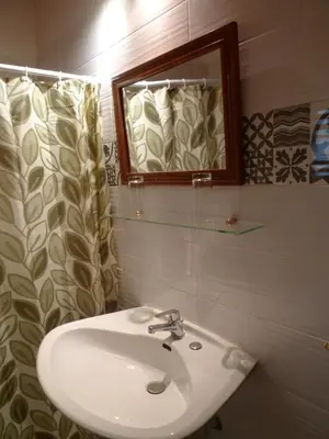 a bathroom with a sink and a mirror at The Wooden Nest, Cozy Private Room in Spáta