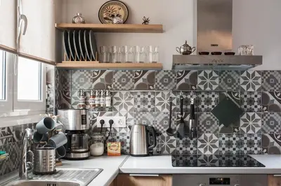 a kitchen with black and white tiles on the wall at Spacious 3br Apartment with Terrace in Exarchea in Athens