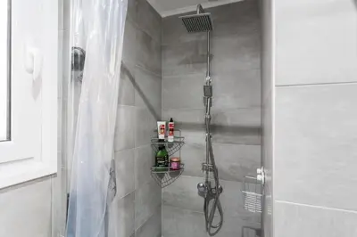 a bathroom with a shower with a shower at Spacious 3br Apartment with Terrace in Exarchea in Athens