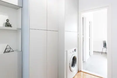 a white laundry room with a washer and dryer at Spacious 3br Apartment with Terrace in Exarchea in Athens