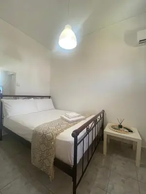 a bedroom with a bed and a table with a lamp at Penthouse in apartment building, in the Center in Athens