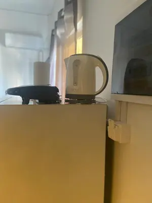 a coffee cup sitting on top of a refrigerator at Penthouse in apartment building, in the Center in Athens