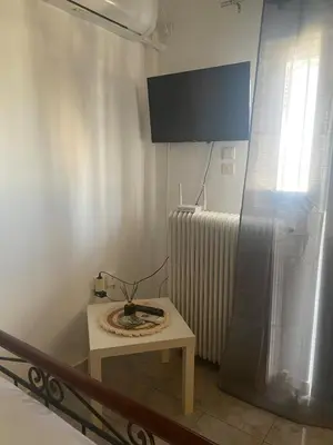 a small table in a room with a radiator at Penthouse in apartment building, in the Center in Athens