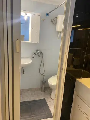 a small bathroom with a toilet and a sink at Penthouse in apartment building, in the Center in Athens