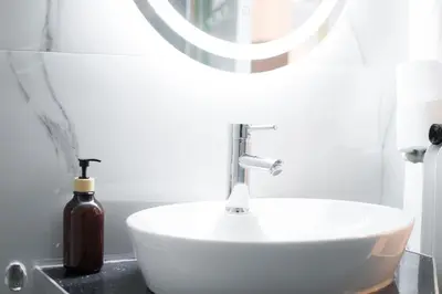a bathroom with a white sink and a mirror at Central Nest near Acropolis in Athens