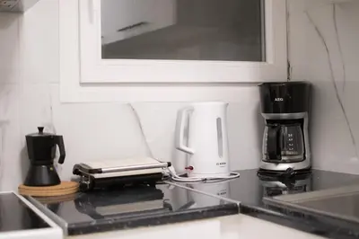 a kitchen counter with a coffee maker and a coffeemaker at Central Nest near Acropolis in Athens