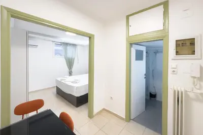 a bedroom with a bed and a bathroom with a mirror at Central Nest near Acropolis in Athens