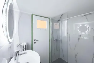 a bathroom with a shower and a toilet and a sink at Central Nest near Acropolis in Athens