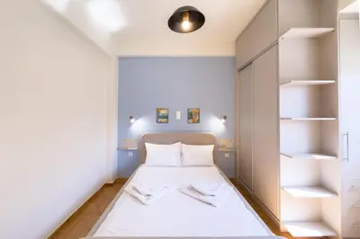 a small bedroom with a bed and shelves at Panormou Neon - Urban Apartment 3A in Athens