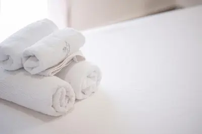 a white stuffed animal is sitting on a table at Panormou Neon - Urban Apartment 3B in Athens