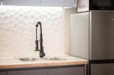 a kitchen with a sink and a refrigerator at Panormou Neon - Urban Apartment 3B in Athens