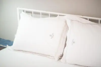 two white pillows sitting on top of a bed at Panormou Neon - Urban Apartment 3B in Athens