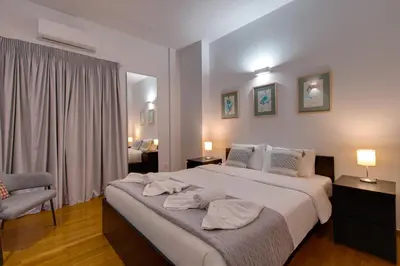 a bedroom with a large bed with two towels on it at Stylish Flat between Syntagma Sq and Kolonaki in Athens