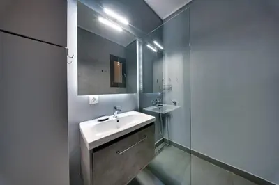 a bathroom with a sink and a mirror at Stylish Flat between Syntagma Sq and Kolonaki in Athens