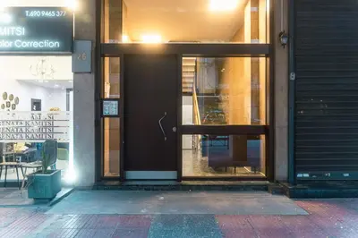 an entrance to a store with a black door at Stylish Flat between Syntagma Sq and Kolonaki in Athens