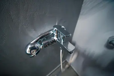 a silver faucet on a wall in a bathroom at Stylish Flat between Syntagma Sq and Kolonaki in Athens