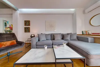 a living room with a couch and a table at Stylish Flat between Syntagma Sq and Kolonaki in Athens