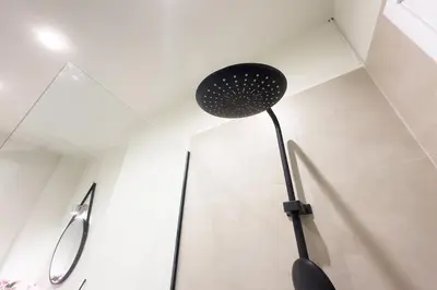 a black lamp in the corner of a room at Panormou Neon - Urban Apartment 4A in Athens