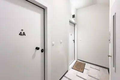 a hallway with two doors and a plaque on the floor at Panormou Neon - Urban Apartment 4B in Athens