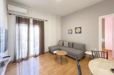a living room with a couch and a table at Panormou Neon - Urban Apartment 4B in Athens