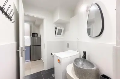 a white bathroom with a sink and a mirror at Panormou Neon - Urban Apartment 4B in Athens