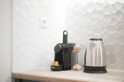 a kitchen counter with a coffee maker and a blender at Panormou Neon - Urban Apartment 4B in Athens