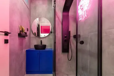 a bathroom with a shower with a sink and a mirror at Morfes studio at historic center-near Acropolis in Athens