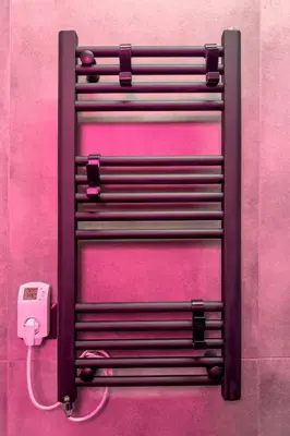 a pink wall with a electrical outlet and a phone at Morfes studio at historic center-near Acropolis in Athens