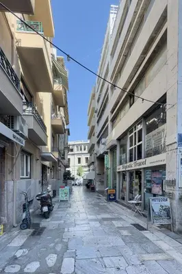 an empty street in a city with buildings at Morfes studio at historic center-near Acropolis in Athens